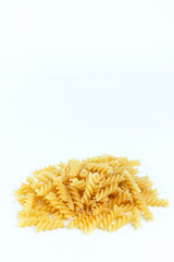 Raw pasta on a white background.