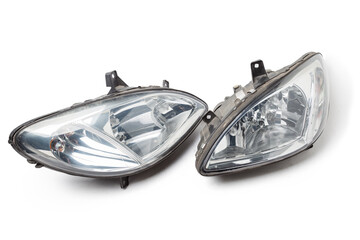 Pair of halogen headlights for auto optical equipment with corrector and lens inside on white isolated in photo studio. Spare part for the repair of the front body in workshop. Spare parts catalog.