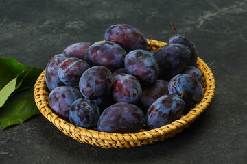 Ripe plum heap in the basket