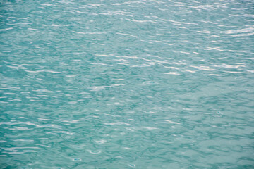 Sea water. Turquoise clear water. Summer background. Ocean in cloudy day.