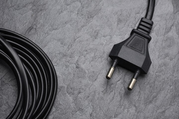 AC power plug type C on black slate background