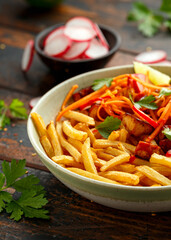 Loaded French Vegan Fries with tofu, pickled vegetables radish, carrot and spicy hot sauce