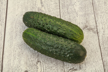 Green fresh cucumbers over background