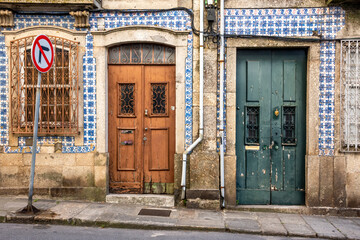 Fototapeta na wymiar Old Derelict Doors in Braga, Portugal, Bordered by Azulejos Tiles