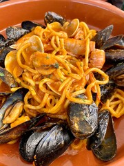 A traditional Italian dish of pasta chitarra and seafood (mussels, shrimps). National Mediterranean cuisine - Spaghetti alla chitarra or maccheroni alla chitarra