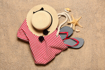 Set of beach accessories on sand, top view