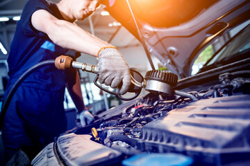 Car mechanic change engine oil. Car repair. Service station