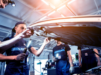 Obraz na płótnie Canvas Car mechanic repair engine at service station. Car repair