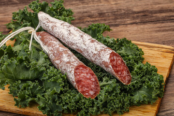 Spanish Fuet sausage with salad leaves