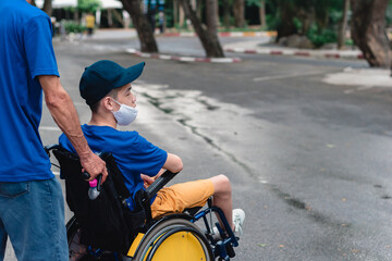 Obraz premium Asian special child on wheelchair wearing mask protection flu Covid 19 or Coronavirus,Wear N95 or cotton masks when to do outdoor activities,New normal to prevent the spread of the virus disease 2020.