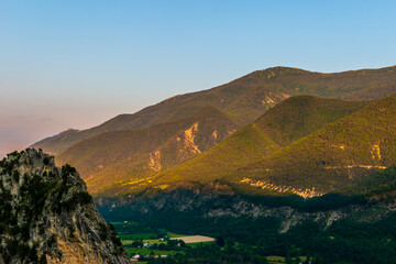 A picturesque landscape view of the Alps mountains and the valley of river Var during sunset (Puget-Theniers, Alpes-Maritimes, France)