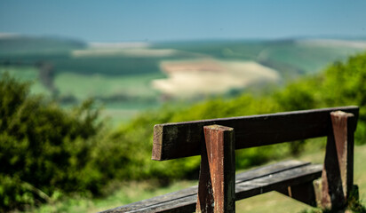 Wood bench on green field with a beautiful view