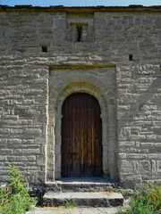 Fototapeta na wymiar Door of the Mozarab Pre-Romanesque or Romanesque Church of San Juan de Busa in the Serrablo Region. 10th-11th century. Aragon. Spain. 