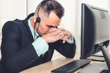Business people wearing headset feel unhappy working in office . Failure negative sadness emotion concept of call center, telemarketing and customer support crisis in financial economy down fall .