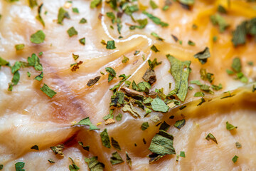 Background with skin of fried chicken with homemade herbs in soft focus at high magnification
