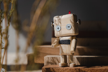 small wooden robot in the wooden jungle. loneliness concept