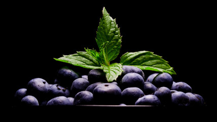 Blueberries macro view. Fresh blueberry close up view. Bio organic blueberries on a black background. Vegan snack, healthy breakfast