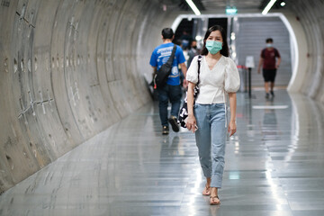 Asian girl wear surgical mask to protect the Covid-19 virus in public areas, New normal lifestyle
