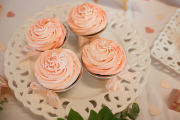 Cupcakes with pink frosting on a party table