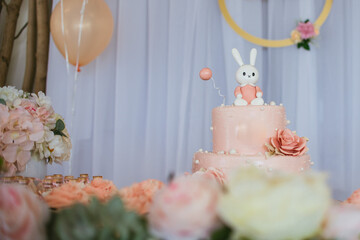 1st birthday cake decorated with flowers and a bunny