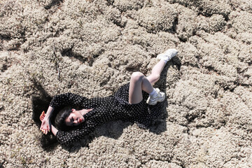 Woman laying on a dry moss