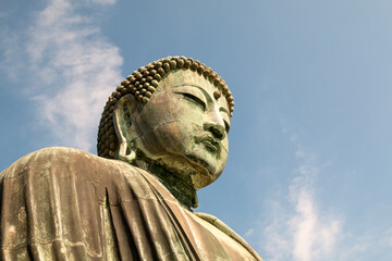 Colse up of Daibutsu statue at Kotoku-in Temple  Monumental outdoor bronze statue of Amida Buddha which is most famous of Japan © Meng_Dakara