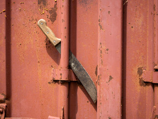 machete is inserted into the metal door