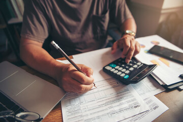 Accountant calculate tax return and work at home, Asian businessman planning budget, account...