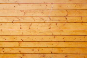 Fototapeta premium Yellow painted wood wall from planks. Background texture. Close up view