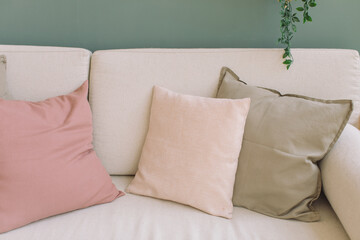 Set of pastel color mock up cushions on sofa, interior design concept.