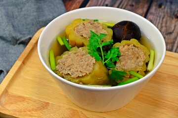 Stuffed bitter gourd with seasoned minced pork in clear soup.