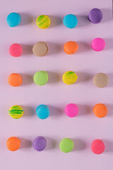 Creative composition with envelope and cake macaron or macaroon on pink pastel background top view. Flat lay.