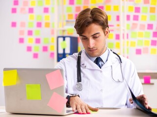 Male doctor with many conflicting prioritites