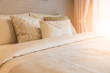 close up white beige soft pillows on bed and blanket bedroom interior design concept.bed maid luxury ideas concept