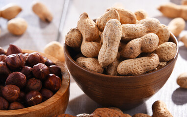 Composition with two bowls of hazelnuts and peanuts
