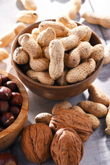 Composition with two bowls of hazelnuts and peanuts