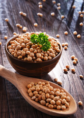 Composition with bowl of soya beans on wooden table
