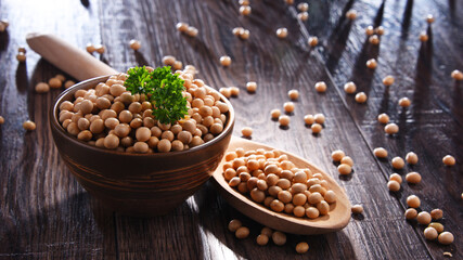 Composition with bowl of soya beans on wooden table