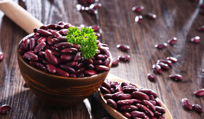 Composition with bowl of kidney bean on wooden table - obrazy, fototapety, plakaty
