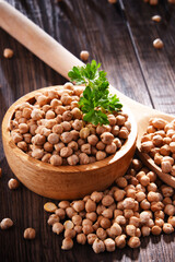 Composition with bowl of chickpeas on wooden table