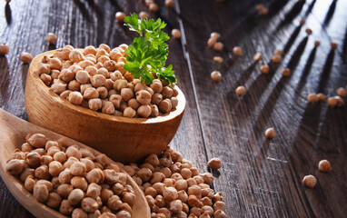 Composition with bowl of chickpeas on wooden table