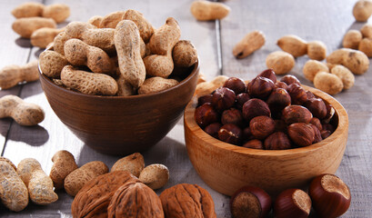 Composition with two bowls of hazelnuts and peanuts