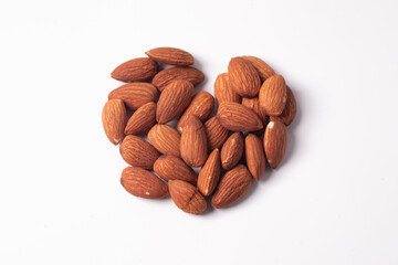 Heart shaped almonds on a white background