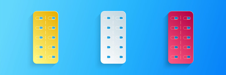 Paper cut Pills in blister pack icon isolated on blue background. Medical drug package for tablet: vitamin, antibiotic, aspirin. Paper art style. Vector.