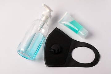 Black mask and hand sanitizer, gel bottle