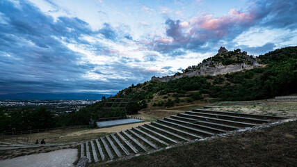 Fototapeta na wymiar Stunning panoramic view of Valence city during sunset from Crussol lookout with amphitheater on the foreground and hill dominating castle on the background.