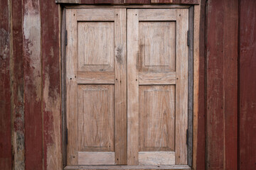 Background/texture of old hardwood window and wooden wall at antique vintage house.