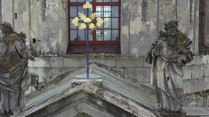 Pidhirtsi village, Lviv region, Ukraine, July, 2020. Church of the Exaltation of the Holy and Life-Giving Cross of the Lord and St. Joseph. The facade of the 18th century temple with sculptures on it.
