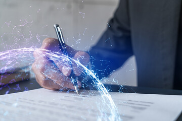 Businessman in suit signs contract. Double exposure with abstract technology hologram. Man signing agreement on research and analysis of high-tech industry.
