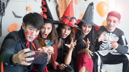 Fototapeta premium Group of 5 friends taking selfie at Halloween costume party. Halloween Holidays and technology concept.